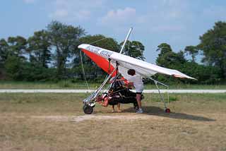 A student climbing into the tandem glider